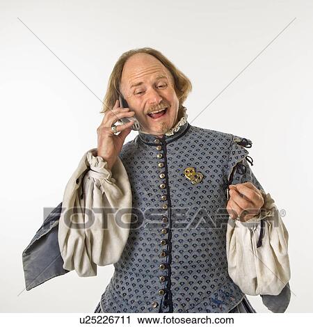Stock Image - William Shakespeare in period clothing talking on cell phone.. Fotosearch