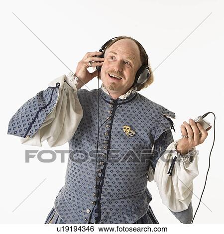 Stock Photograph - William Shakespeare in period clothing listening to mp3 player smiling.. Fotosearch