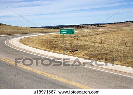 Winding road in South Dakota with mileage distance road sign. View Large Photo Image Stock Photo - Winding road in South Dakota with mileage distance road sign.. Fotosearch