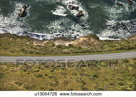 Aerial of coastal scenic highway along Pacific Ocean on California west coast, USA. View Large Photo Image Stock Photograph - Aerial of coastal scenic highway along Pacific Ocean on California west coast, USA.. Fotosearch