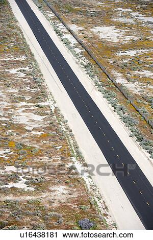 Aerial of two lane highway through desolate landscape. View Large Photo Image Stock Image - Aerial of two lane highway through desolate landscape.. Fotosearch