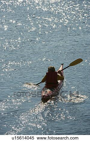 Stock Photography - Aerial of two teenage boys kayaking on Bald Head Island, North Carolina.. Fotosearch