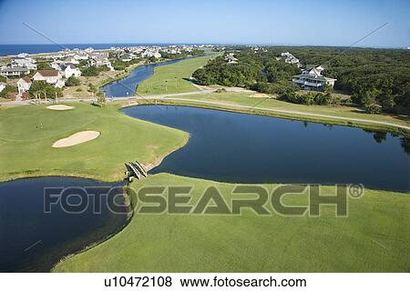 Stock Photo - Aerial view of golf course in coastal residential community at Bald Head Island, North Carolina.. Fotosearch