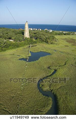 Aerial view of Old Baldy lighthouse in marshy lowlands of Bald Head Island, North Carolina. View Large Photo Image Stock Photo - Aerial view of Old Baldy lighthouse in marshy lowlands of Bald Head Island, North Carolina.. Fotosearch