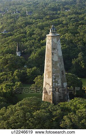 Stock Photo - Aerial view of Old Baldy lighthouse in wooded park at Bald Head Island, North Carolina.. Fotosearch