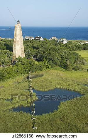 Stock Photo - Aerial view of Old Baldy lighthouse in marshy lowlands of Bald Head Island, North Carolina.. Fotosearch