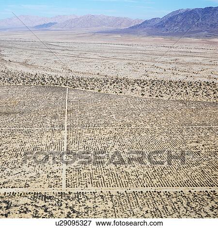 Aerial view of remote California desert with grid pattern and mountain range in background. View Large Photo Image Stock Photo - Aerial view of remote California desert with grid pattern and mountain range in background.. Fotosearch