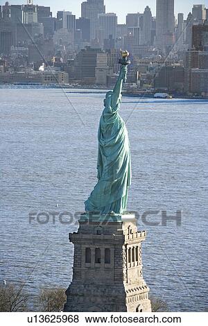 Aerial view of Statue of Liberty with Manhattan, New York buildings in background. View Large Photo Image Stock Photo - Aerial view of Statue of Liberty with Manhattan, New York buildings in background.. Fotosearch