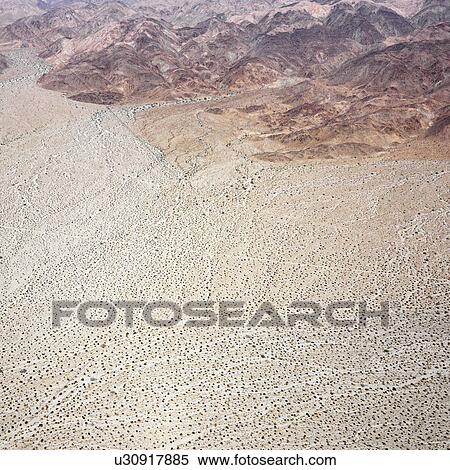 Stock Photography - Aerial view of torrid California desert with rocky landforms.. Fotosearch