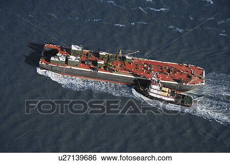Aerial view of tugboat pushing tanker. View Large Photo Image Stock Photograph - Aerial view of tugboat pushing tanker.. Fotosearch