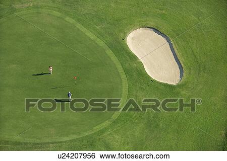 Aerial view of two people playing golf at Bald Head Island, North Carolina. View Large Photo Image Stock Photograph - Aerial view of two people playing golf at Bald Head Island, North Carolina.. Fotosearch