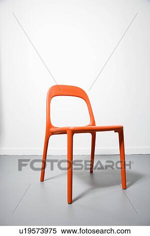 Stock Photography - An orange modern chair with a white background.. Fotosearch