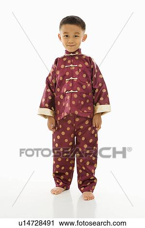 Asian boy standing against white background in traditional attire. View Large Photo Image Stock Image - Asian boy standing against white background in traditional attire.. Fotosearch