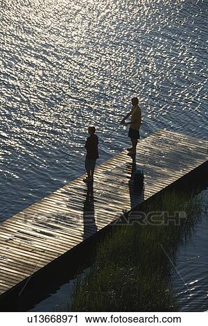 Birds eye view of two teenage boys fishing from dock at Bald Head Island, North Carolina. View Large Photo Image Stock Image - Birds eye view of two teenage boys fishing from dock at Bald Head Island, North Carolina.. Fotosearch