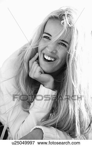 Stock Photo - Black and white head and shoulder portrait of pretty blond Caucasian woman smiling and laughing.. Fotosearch