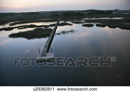 Boat dock and walkway over marsh at Bald Head Island North Carolina View Large Photo Image Stock Image - Boat dock and walkway over marsh at Bald Head Island North Carolina. Fotosearch