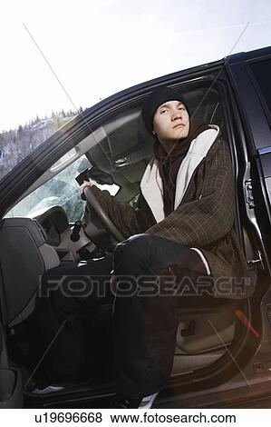 Caucasian male teenager sitting in SUV looking at viewer. View Large Photo Image Stock Photo - Caucasian male teenager sitting in SUV looking at viewer. . Fotosearch