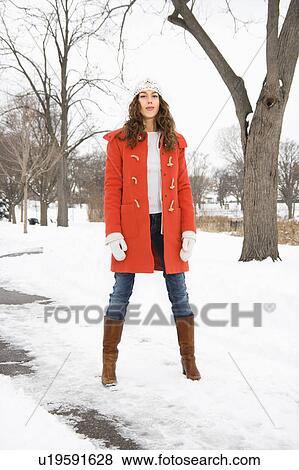 Caucasian young adult female looking at viewer and standing in snow covered street. View Large Photo Image Stock Photo - Caucasian young adult female looking at viewer and standing in snow covered street.. Fotosearch