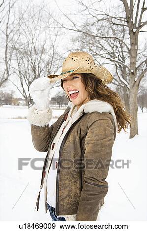 Caucasian young adult female winking and tilting straw cowboy hat at viewer. View Large Photo Image Stock Photo - Caucasian young adult female winking and tilting straw cowboy hat at viewer.. Fotosearch