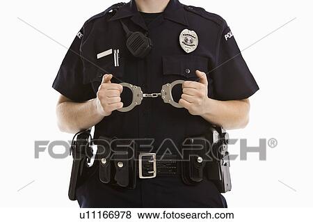 Stock Photo - Close up of mid adult Caucasian policewoman holding locked handcuffs.. Fotosearch