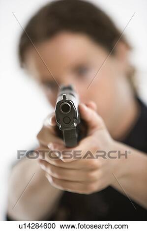 Close up of mid adult female Caucasian law enforcement officer aiming gun at viewer. View Large Photo Image Stock Image - Close up of mid adult female Caucasian law enforcement officer aiming gun at viewer.. Fotosearch