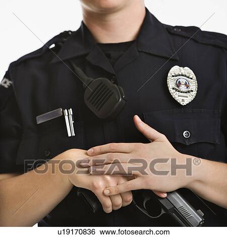 Close up of mid adult female Caucasian law enforcement officer with hands on gun. View Large Photo Image Stock Photograph - Close up of mid adult female Caucasian law enforcement officer with hands on gun.. Fotosearch