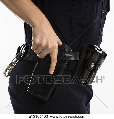 Close up side view of mid adult female Caucasian law enforcement officer hand on gun in holster. View Large Photo Image Stock Image - Close up side view of mid adult female Caucasian law enforcement officer hand on gun in holster.. Fotosearch