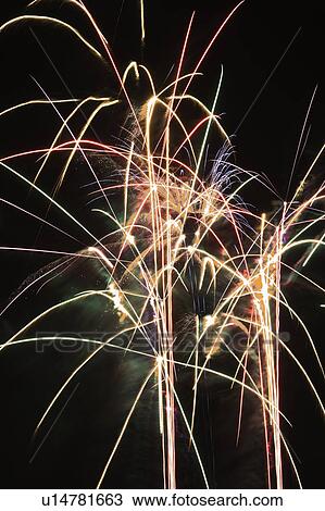 Stock Image - Colorful fireworks exploding in night sky.. Fotosearch