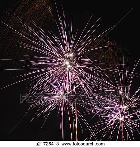 Stock Image - Colorful fireworks exploding in night sky.. Fotosearch