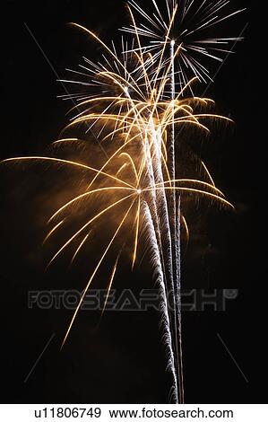 Stock Photo - Colorful fireworks exploding in night sky.. Fotosearch