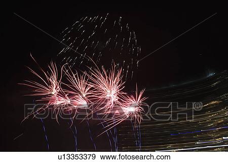 Stock Photo - Colorful fireworks exploding in night sky.. Fotosearch