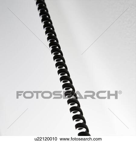 Stock Image - Curly black telephone cord.. Fotosearch