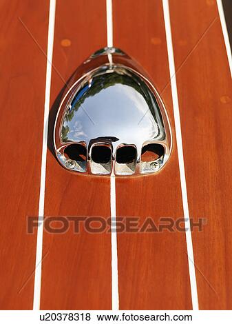 Stock Photo - Detail of metal vent on wooden boat.. Fotosearch
