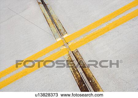 Detail of solid double yellow line in road crossing metal strips in cement. View Large Photo Image Stock Image - Detail of solid double yellow line in road crossing metal strips in cement.. Fotosearch
