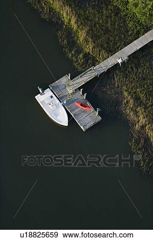 Dock with motorboat and kayak. View Large Photo Image Stock Photo - Dock with motorboat and kayak.. Fotosearch