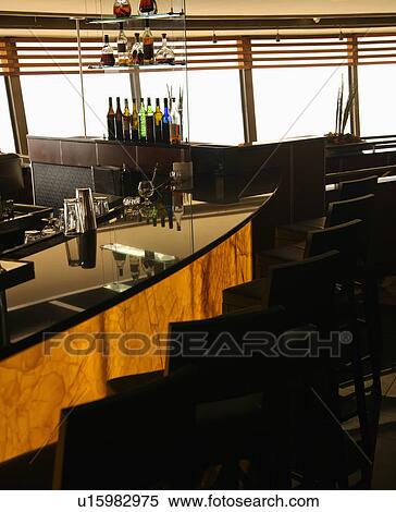 Empty bar in restaurant with row of barstools and windows in background. View Large Photo Image Stock Photography - Empty bar in restaurant with row of barstools and windows in background. . Fotosearch