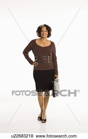 Full length portrait of businesswoman standing with hand on hip holding briefcase. View Large Photo Image Stock Photo - Full length portrait of businesswoman standing with hand on hip holding briefcase.. Fotosearch