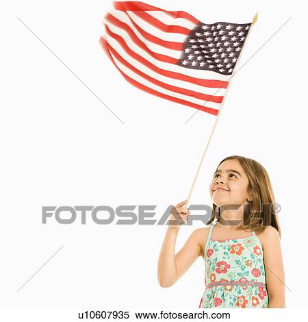 Girl holding American flag against white background. View Large Photo Image Stock Photography - Girl holding American flag against white background.. Fotosearch