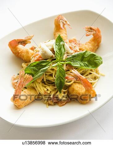 Gourmet meal with fried shrimp and pasta garnished with fresh basil. View Large Photo Image Stock Photo - Gourmet meal with fried shrimp and pasta garnished with fresh basil.. Fotosearch