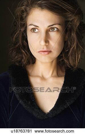 Stock Image - Head and shoulder portrait of pretty brunette woman.. Fotosearch