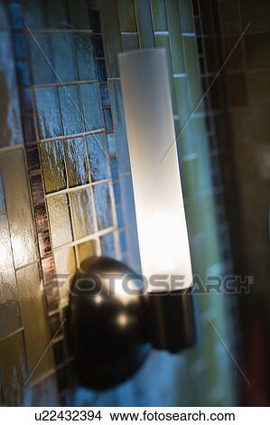 Picture - Interior shot of tile wall with lamp.. Fotosearch