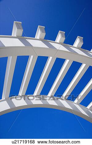 Low angle view of arched white trellis with blue sky. View Large Photo Image Stock Photo - Low angle view of arched white trellis with blue sky.. Fotosearch
