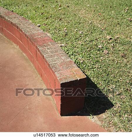 Stock Image - Low brick wall in park.. Fotosearch