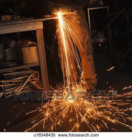 Metalsmith shaping metal and creating sparks. View Large Photo Image Stock Photography - Metalsmith shaping metal and creating sparks.. Fotosearch