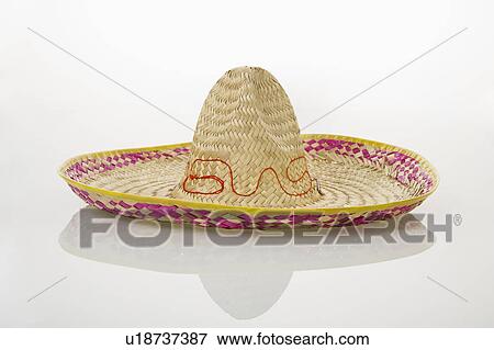 Stock Photo - Mexican straw sombrero hat on white background.. Fotosearch