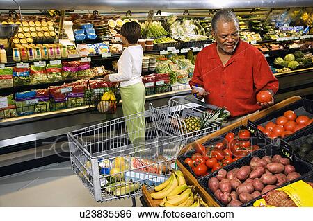 Middle aged African American man and woman in grocery store shopping for produce. View Large Photo Image Stock Photograph - Middle aged African American man and woman in grocery store shopping for produce.. Fotosearch