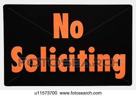 Stock Image - No soliciting sign with orange text against black.. Fotosearch