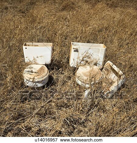 Old toilets that were dumped in field. View Large Photo Image Stock Photo - Old toilets that were dumped in field.. Fotosearch