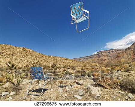 One lawn chair on ground and other up in the air in desert landscape. View Large Photo Image Stock Photography - One lawn chair on ground and other up in the air in desert landscape.. Fotosearch
