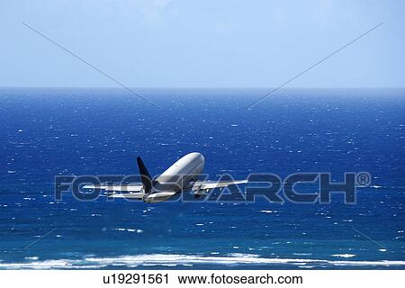 Passenger airplane taking off from airport headed over the Pacific ocean. View Large Photo Image Stock Image - Passenger airplane taking off from airport headed over the Pacific ocean.. Fotosearch